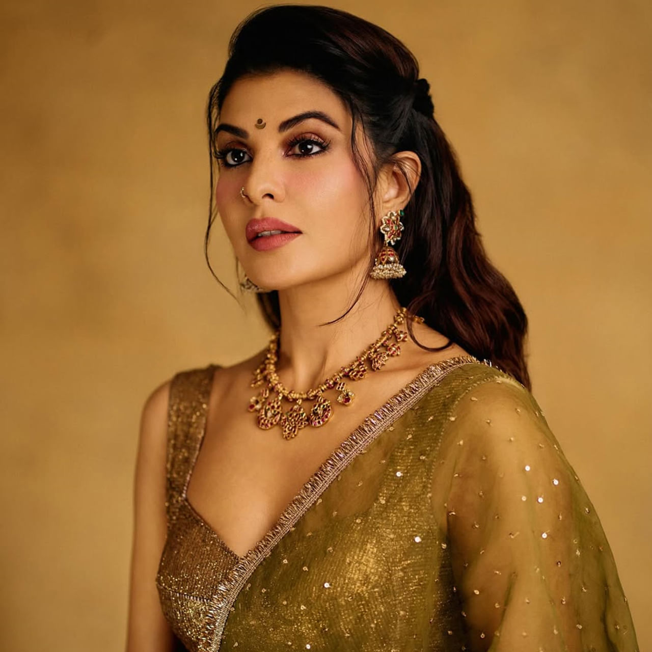 బాలీవుడ్ గ్లామర్ బ్యూటీ జాక్వెలిన్ ఫెర్నాండెజ్ ఇప్పుడు పట్టు పరికిణిలో కట్టిపడేస్తుంది. నిత్యం మోడ్రన్ ఫోజులతో నెట్టింట రచ్చ చేసిన ఈ అమ్మడు.. ఇప్పుడు బంగారు రంగు బ్లౌజ్  ధరించి, గులాబీ రంగు లెహంగా, దుపట్టా ధరించింది. 