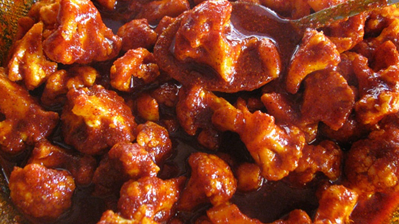 ఇప్పుడు ఒక గిన్నె తీసుకుని ఆరబెట్టిన కాలిఫ్లవర్ ముక్కలను తీసుకుని దానిలో రుచికి తగినంత ఉప్పు, అర టీ స్పూన్ కారం, అర టీ స్పూన్ ఆవపొడి, వెల్లుల్లి రెబ్బలు వేసుకుని బాగా కలుపుకోవాలి.