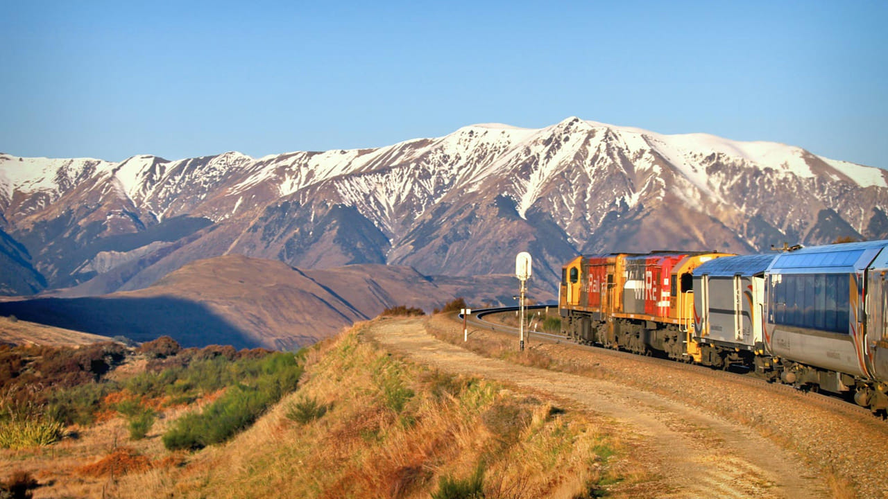 TranzAlpine, New Zealand- ట్రాన్జ్ ఆల్పైన్ రైలు, న్యూ జీలాండ్: న్యూజిలాండ్‌లోన్ ట్రాన్సాల్పైన్ రైలు మార్గం ద్వారా ప్రయాణిస్తూ పంటపొలాలు,ఇరుకైన లోయలు వంటి ప్రదేశాలను చూడవచ్చు. ప్రకృతి ప్రేమికుల కోసం న్యూ జీలాండ్‌లోని ట్రాన్జ్ ఆల్పైన్ రైలు అత్యంత అందమైన మార్గాల్లో ఒకటి. క్రైస్ట్‌చర్చ్ నుండి గ్రేంథమౌత్ వరకు సుమారు 223 కిలోమీటర్ల విస్తీర్ణంలో ప్రయాణం చేస్తుంది. ఈ రైలు మార్గం సన్యాసాల పర్వతాలు, నదులు, చల్లని సరస్సులు, ఆకుపచ్చ అడవులు మరియు మంచుతో కప్పబడిన పర్వత శ్రేణులను చూపిస్తుంది. కిటికీ ద్వారా అందే ప్రతి దృశ్యం ఫోటోగ్రఫీ ప్రేమికులను మైమరిపిస్తుంది. సుమారు 5 గంటల ప్రయాణంలో, ప్రయాణికులు న్యూ జీలాండ్ ప్రకృతి అందాలను సమీపంగా అనుభవించవచ్చు. ఇది అడ్వెంచర్, ట్రావెల్ మరియు ప్రకృతి ప్రేమికులకు కలలైన అనుభవంగా నిలుస్తుంది.