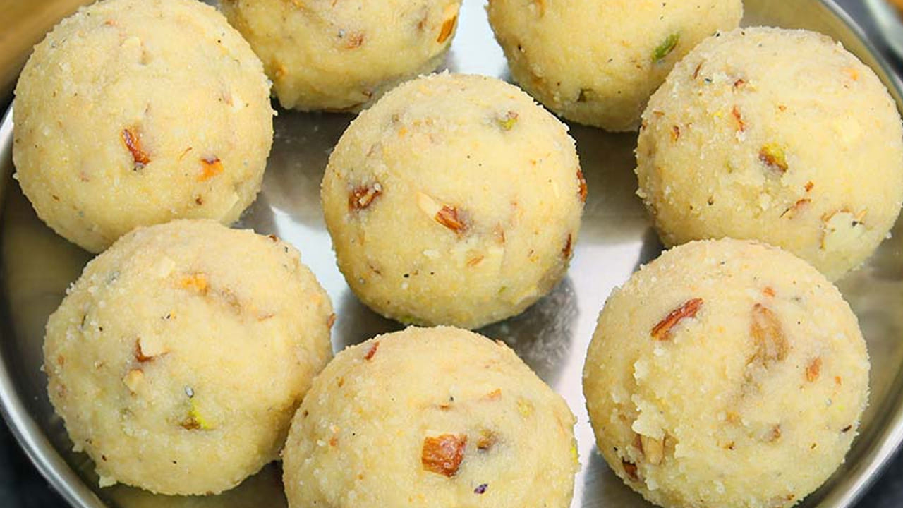 అలాగే పంచదార మొత్తం కరిగిన తర్వాత, రవ్వ, యాలకుల పొడిని వేసి మిక్స్ అయ్యేలా కలపాలి. ఇప్పుడు పాలు పోస్తూ ఉండలు కలుపుకుని ప్లేట్ లో పెట్టుకోవడమే. చివర్లో వేయించిన డ్రై ఫ్రూట్స్ ను కలపాలి. ఇదో వేడిగా ఉన్నప్పుడే నెయ్యి రాసుకుని వీటిని చిన్న లడ్డులుగా చేసుకోవాలి.